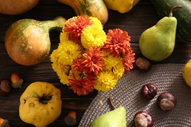 Photo of Autumn flat lay composition with beautiful chrysanthemum flowers and pumpkins on wooden table