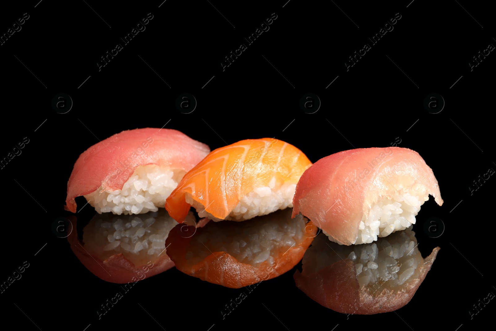 Photo of Delicious nigiri sushi on black background. Traditional Japanese cuisine