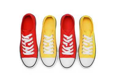 Yellow and red classic old school sneakers isolated on white, top view