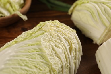 Photo of Fresh Chinese cabbages on wooden table, closeup