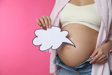 Photo of Pregnant woman with empty paper thought cloud on pink background, closeup. Choosing baby name