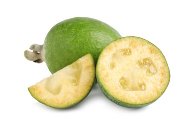 Photo of Whole and cut feijoa fruits on white background