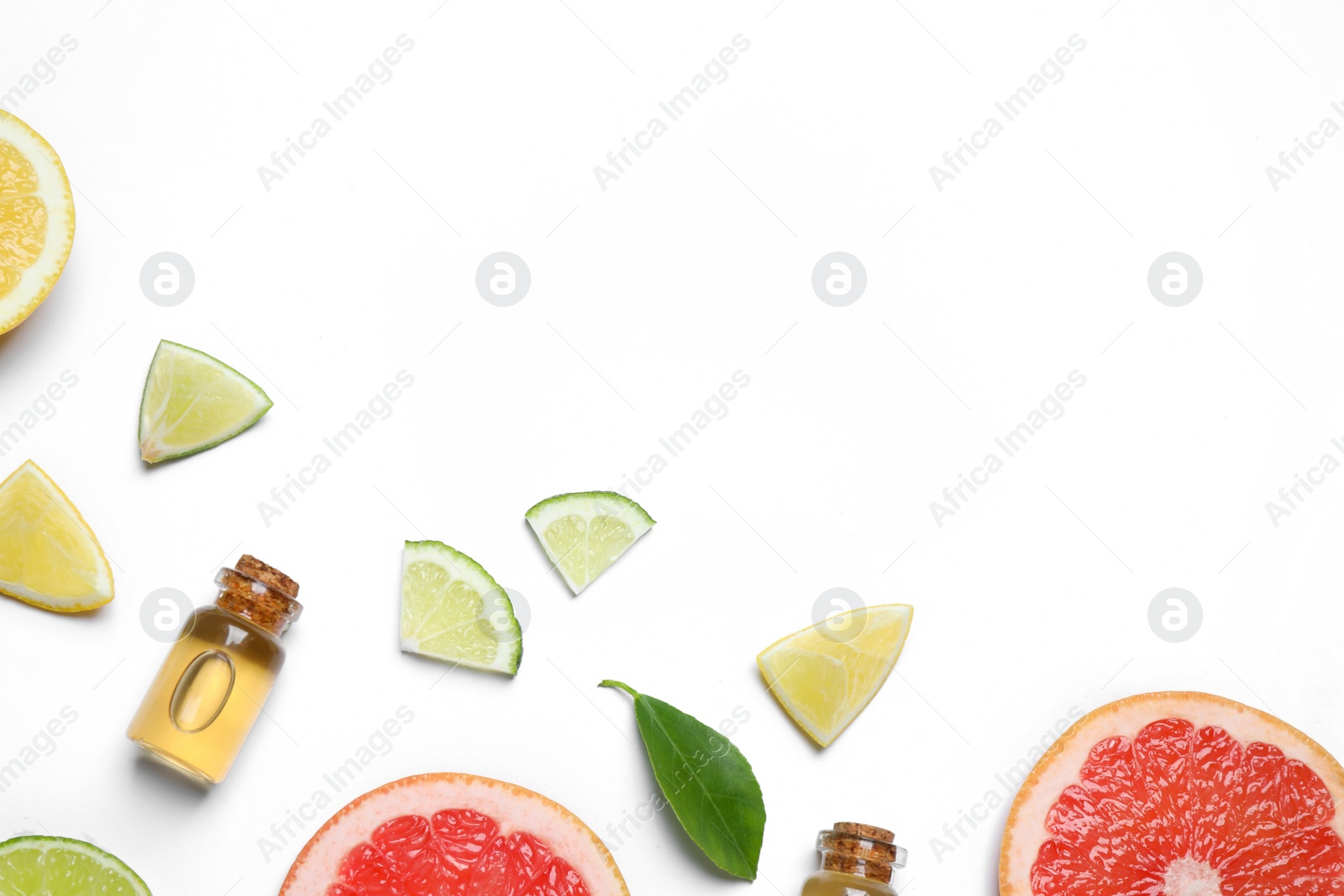 Photo of Flat lay composition with bottles of citrus essential oil on white background