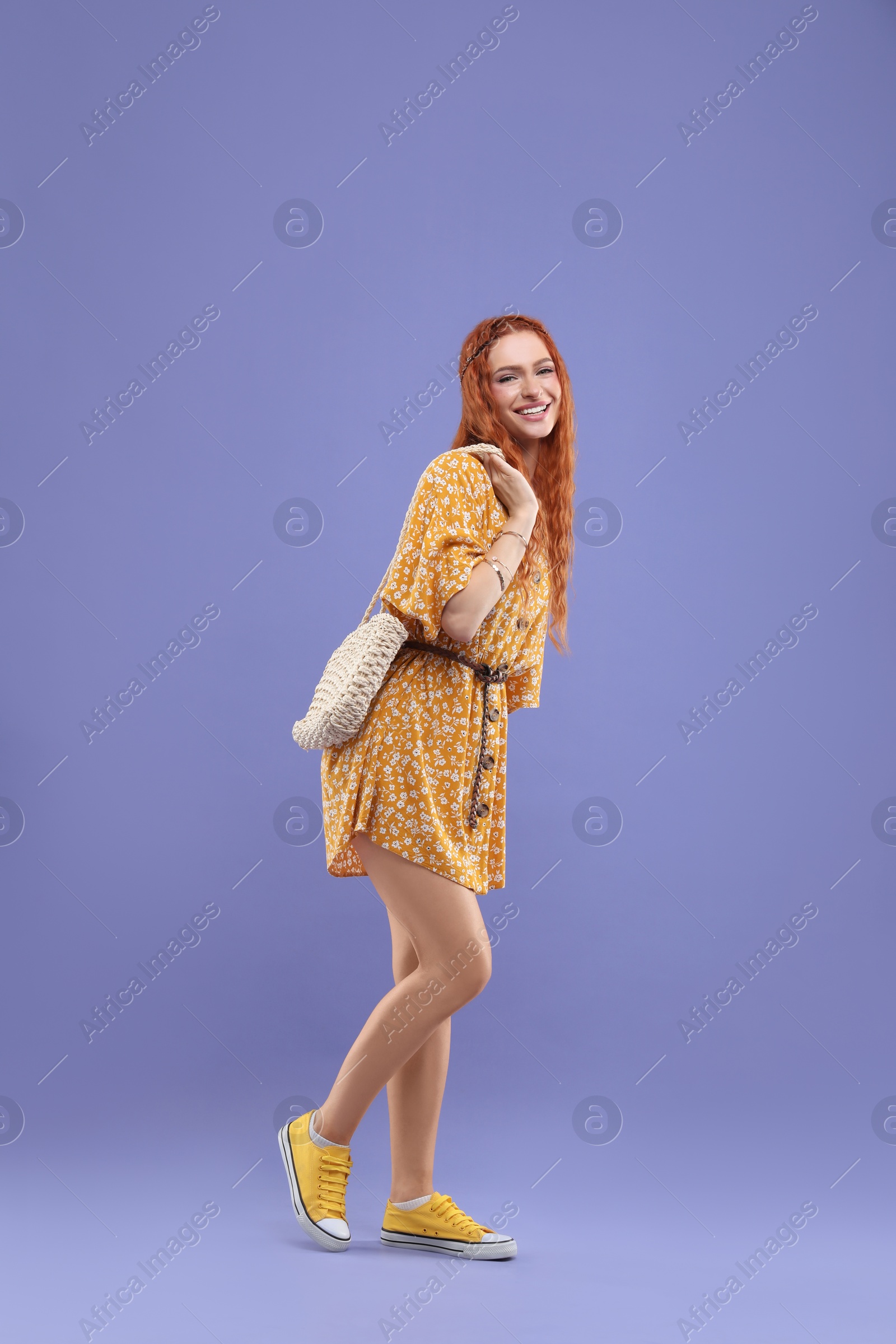 Photo of Stylish young hippie woman on violet background