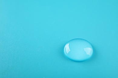 Photo of Beautiful clean water drop on color background