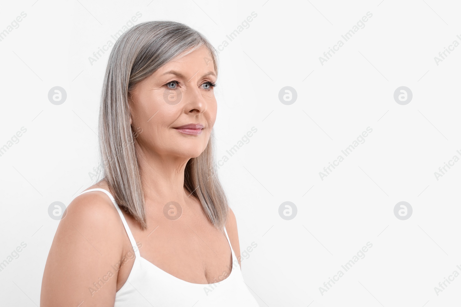 Photo of Portrait of beautiful senior woman on white background. Space for text