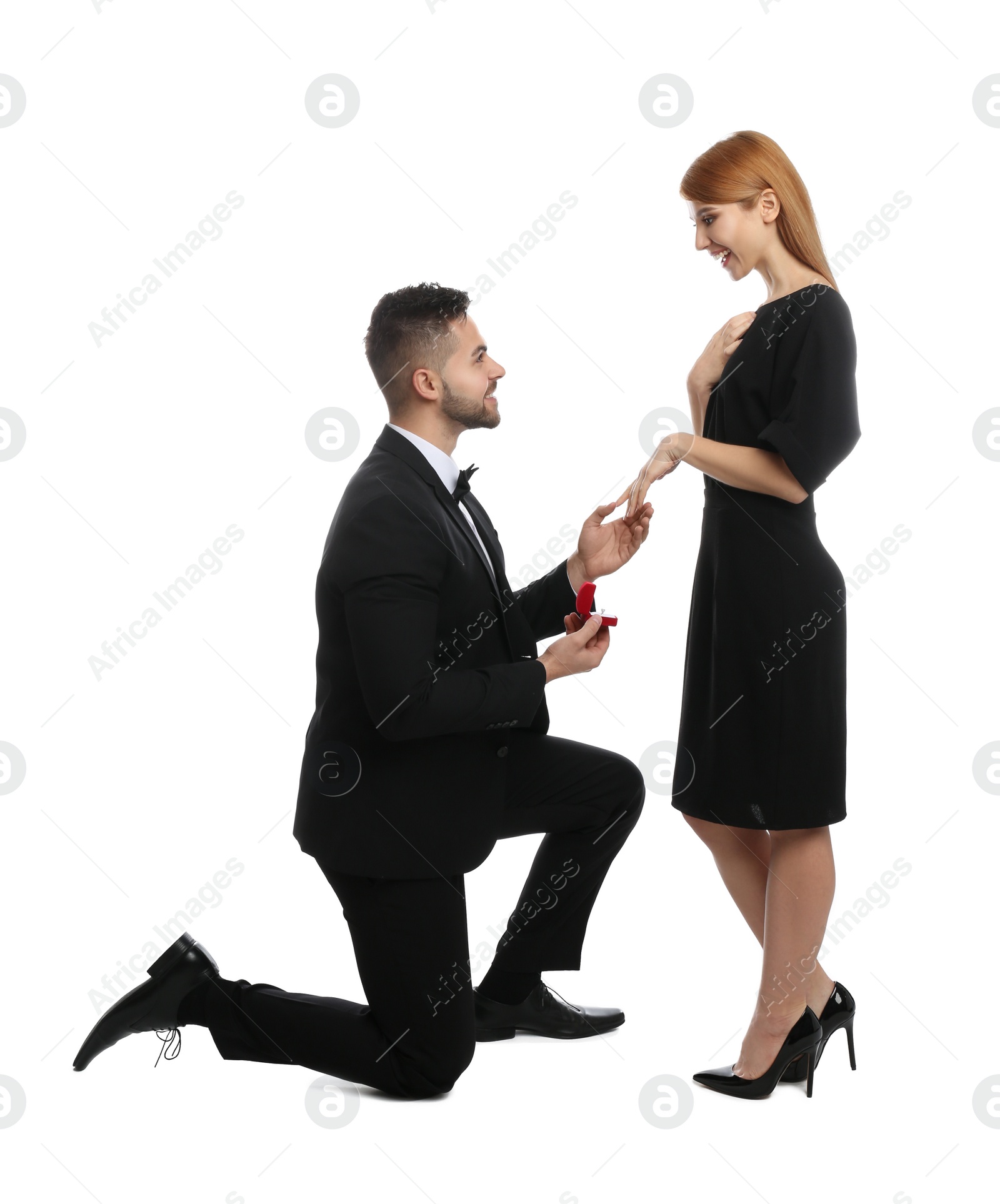 Photo of Man with engagement ring making marriage proposal to girlfriend on white background