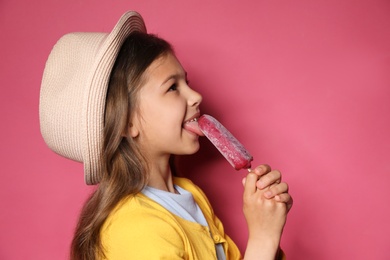 Photo of Adorable little girl with delicious ice cream against color background