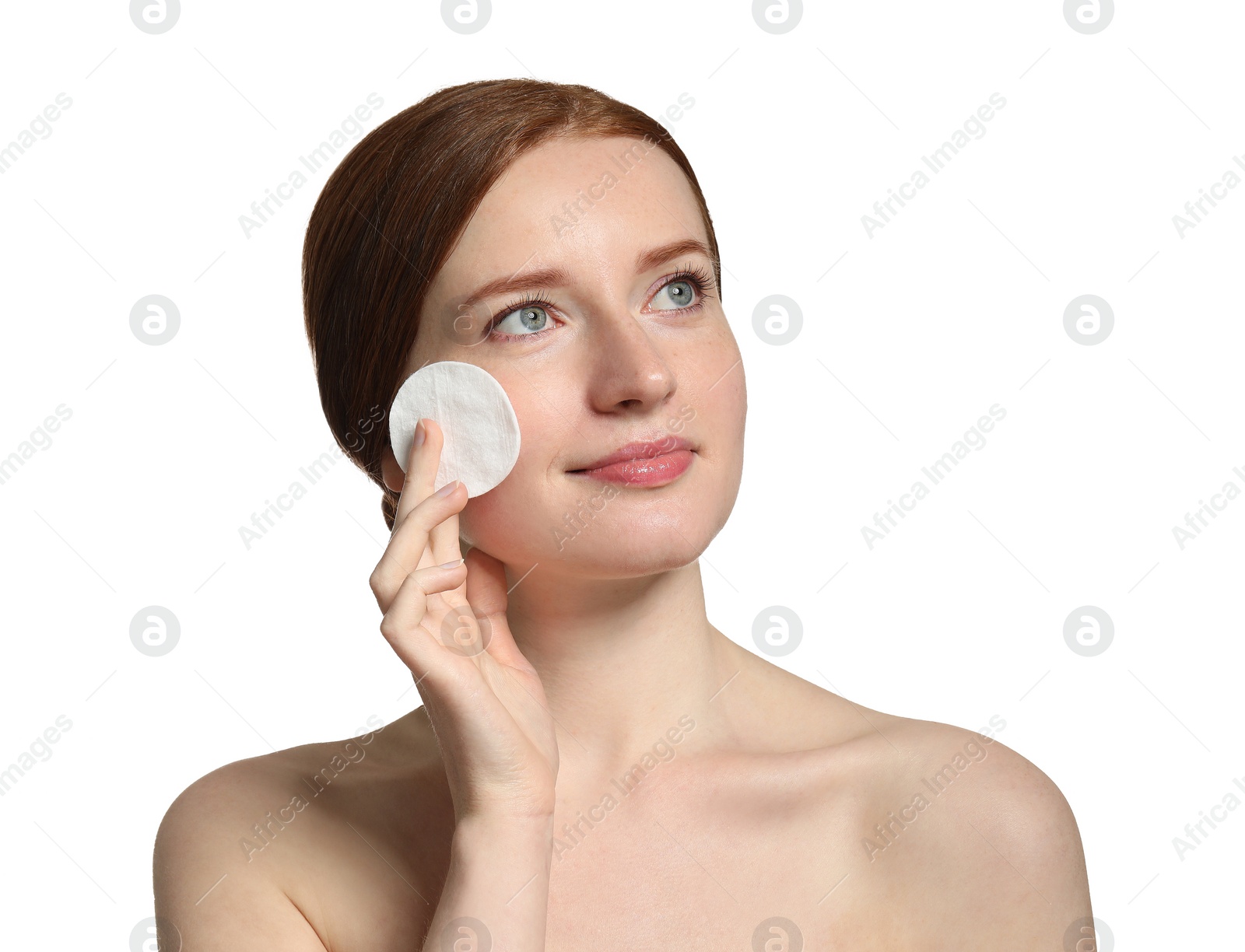 Photo of Beautiful woman with freckles holding cotton pad on white background