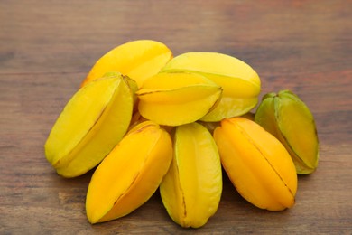 Many delicious ripe carambolas on wooden table