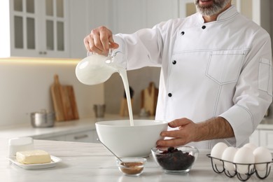 Professional chef making dough at white marble table indoors, closeup