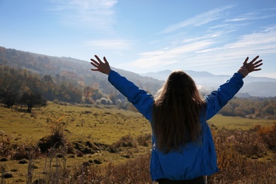 Female traveler feeling free in peaceful mountains