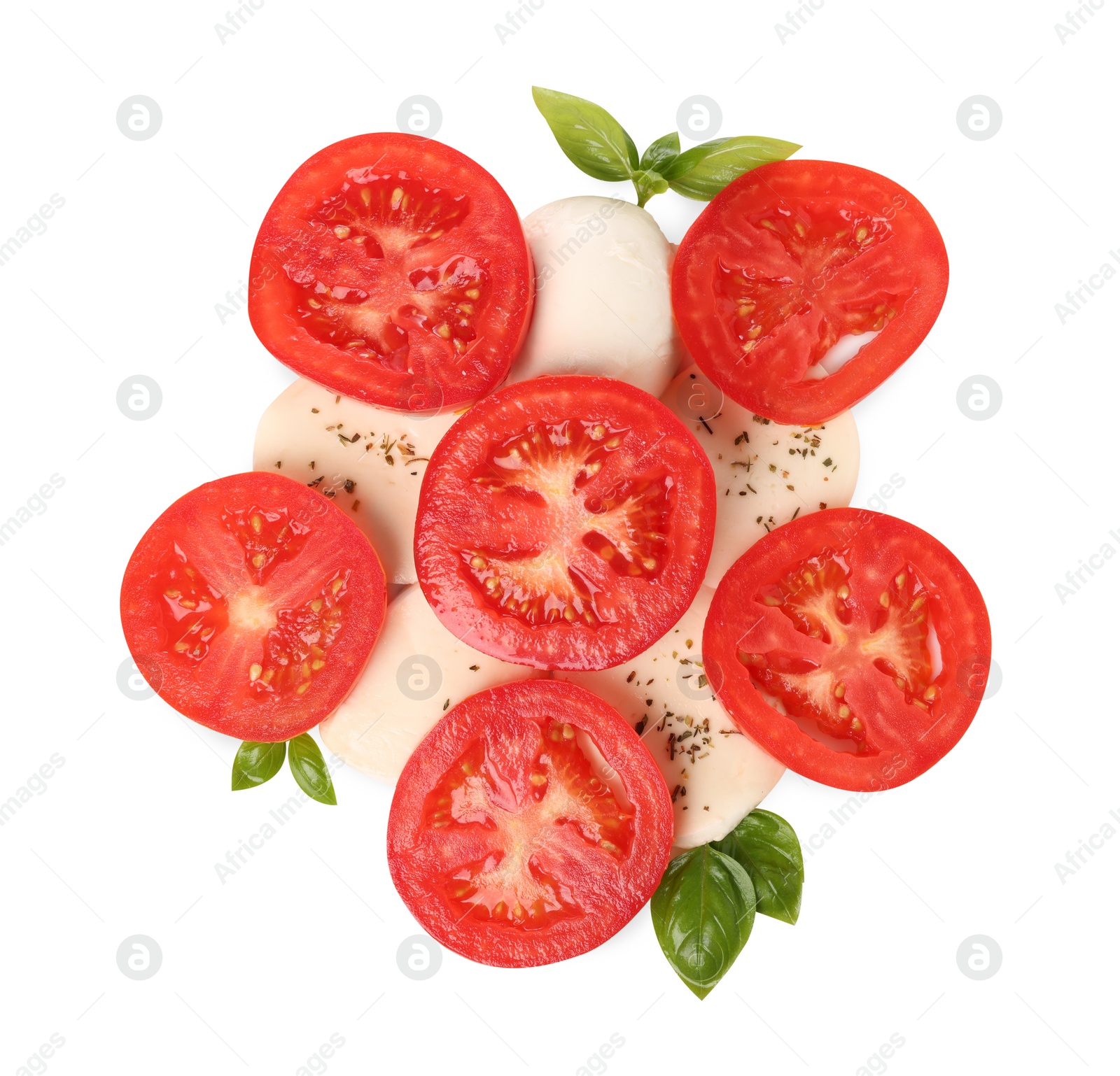 Photo of Delicious Caprese salad with tomatoes, mozzarella cheese, basil leaves and herbs isolated on white, top view