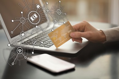 Woman with credit card using laptop for online payment at table, closeup