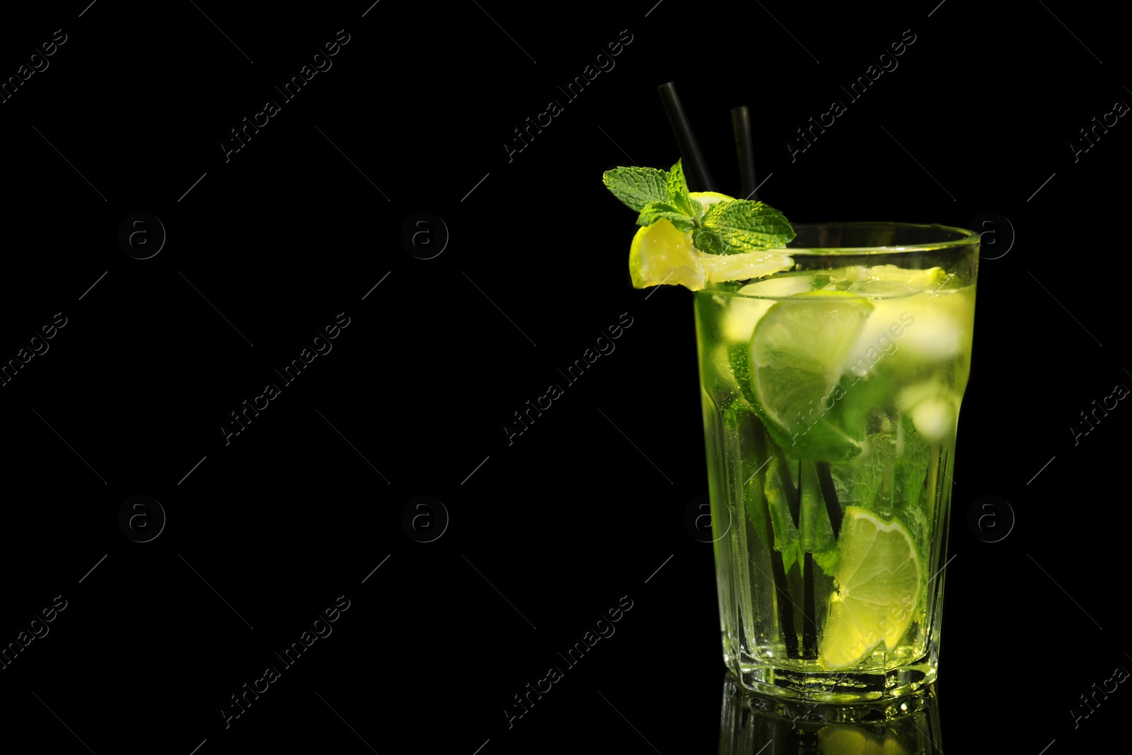 Photo of Glass of delicious cocktail on black background. Space for text