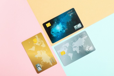 Photo of Different plastic credit cards on color background, flat lay
