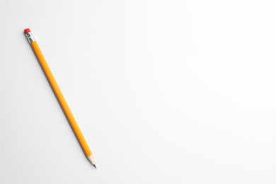 Photo of Sharp graphite pencil with eraser on white background, top view. Space for text