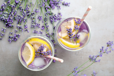 Photo of Fresh delicious lemonade with lavender on grey table, flat lay