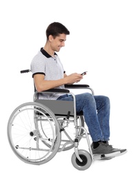 Photo of Young man in wheelchair using mobile phone isolated on white