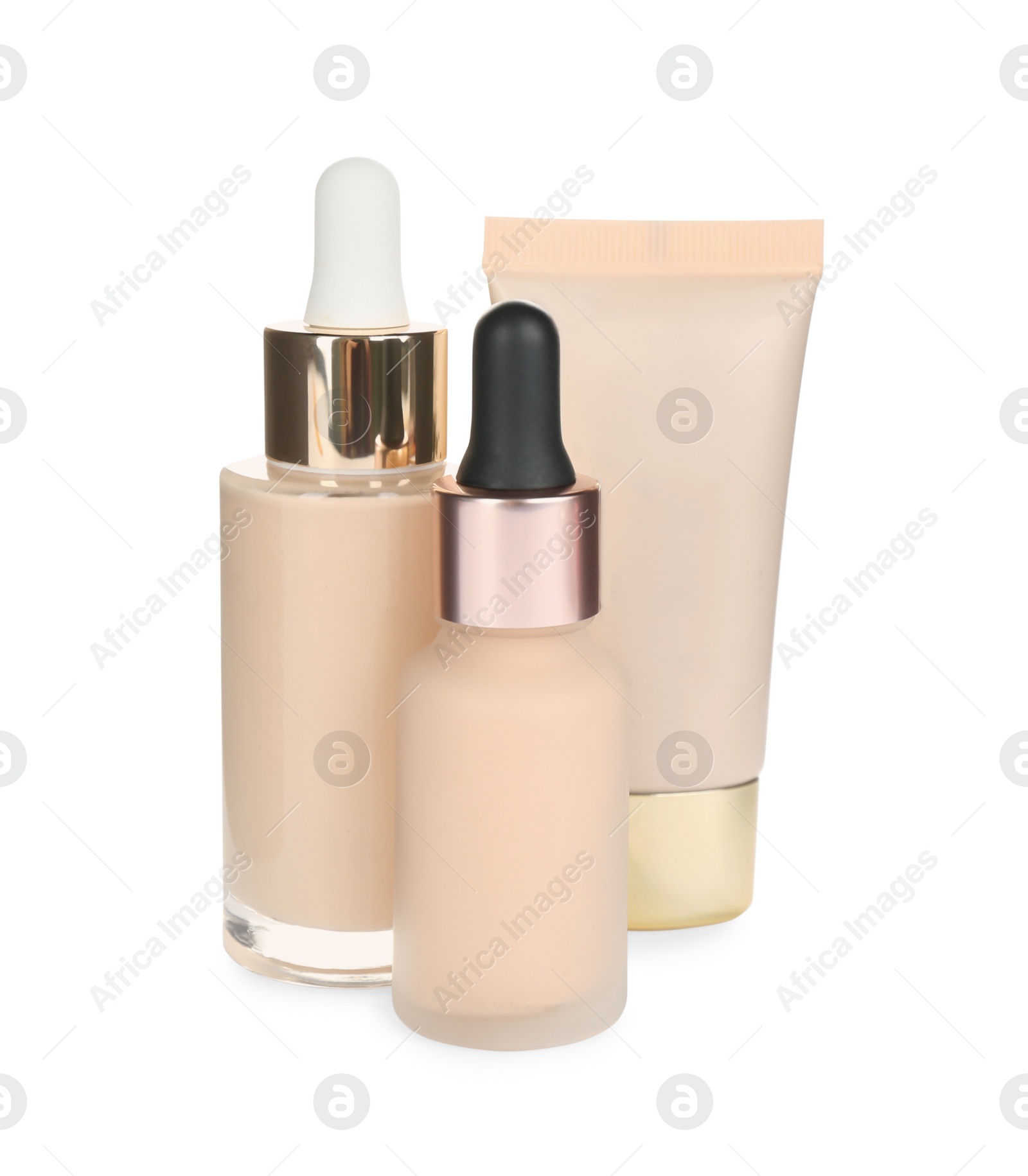 Photo of Bottles and tube with skin foundation on white background. Makeup products