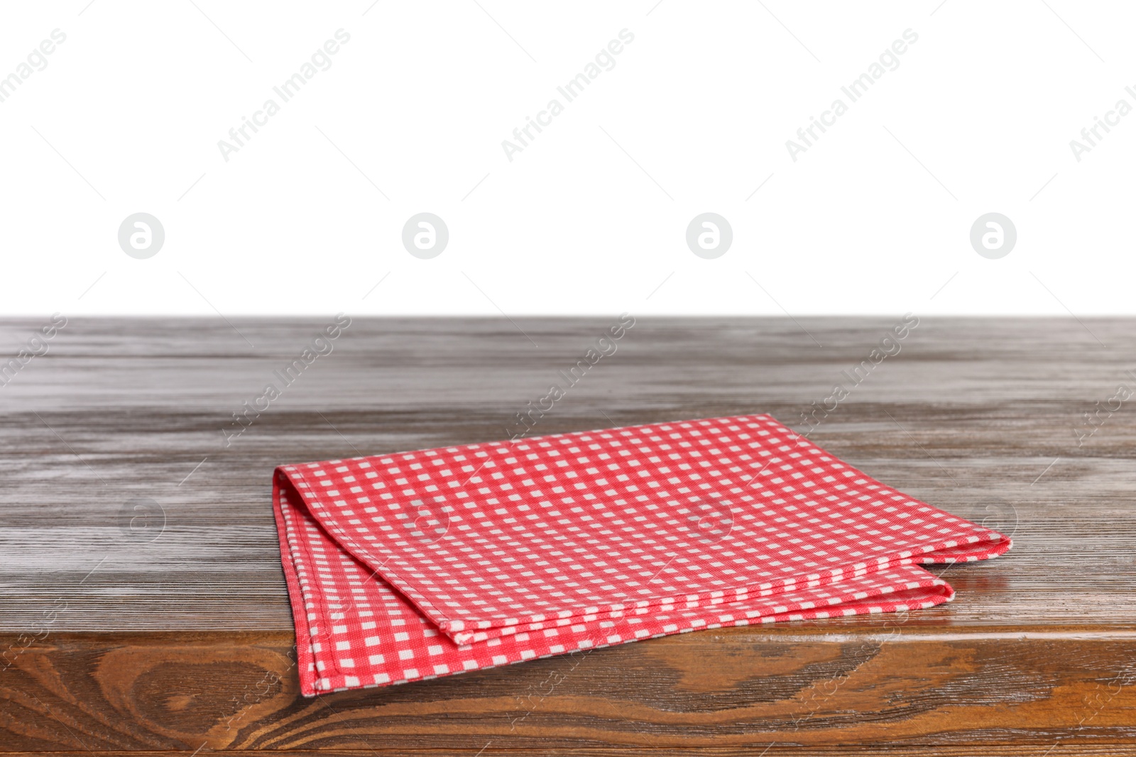 Photo of Checkered tablecloth on wooden table against white background