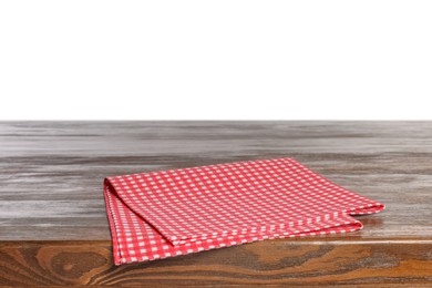 Checkered tablecloth on wooden table against white background