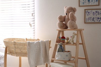 Photo of Decorative ladder with toys and different stuff in stylish baby room. Idea for interior design