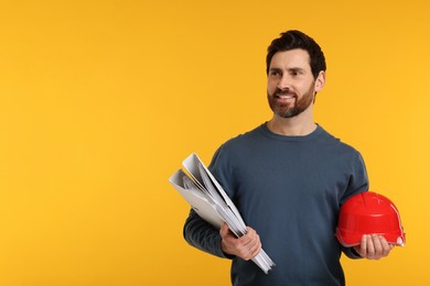 Photo of Architect with hard hat and folders on orange background, space for text