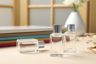 Bottles of essential oil on beige table