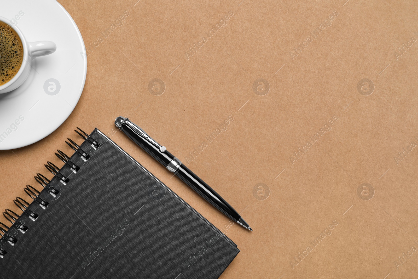 Photo of Flat lay composition with stylish notebook on brown background. Space for text