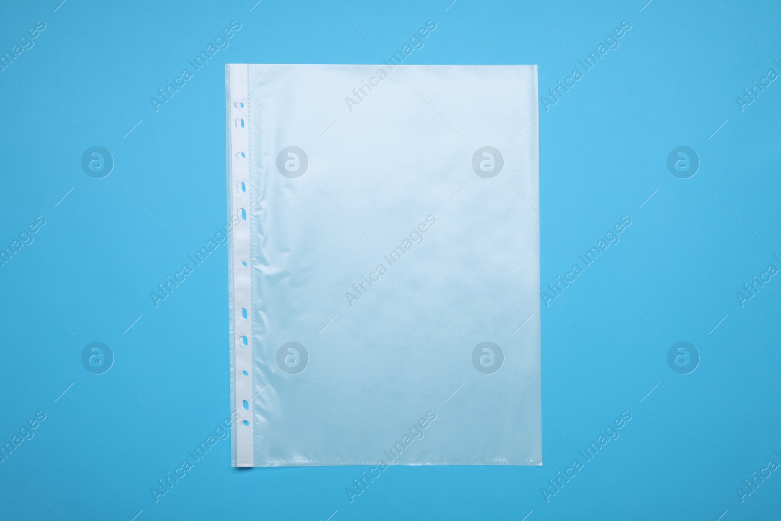 Photo of Punched pocket on light blue background, top view