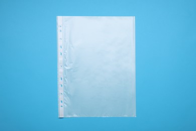 Photo of Punched pocket on light blue background, top view
