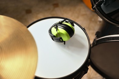 Photo of Modern drum, headphones and cymbal in studio