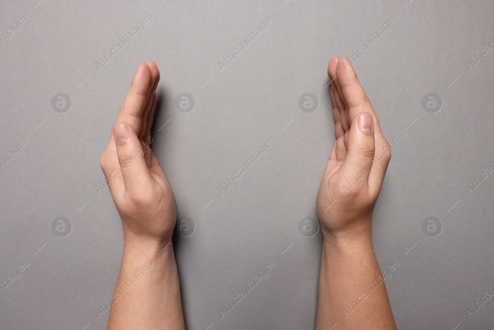 Photo of Woman holding on grey background, closeup of hands. Space for text