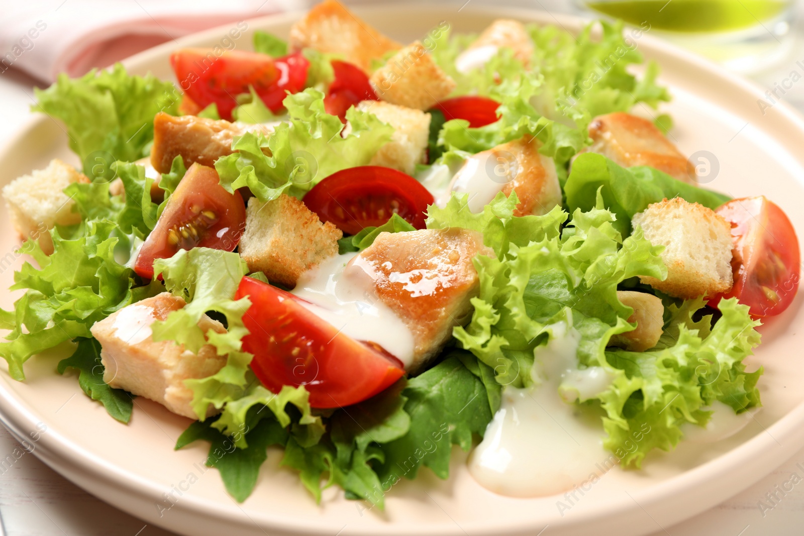 Photo of Delicious fresh Caesar salad on plate, closeup