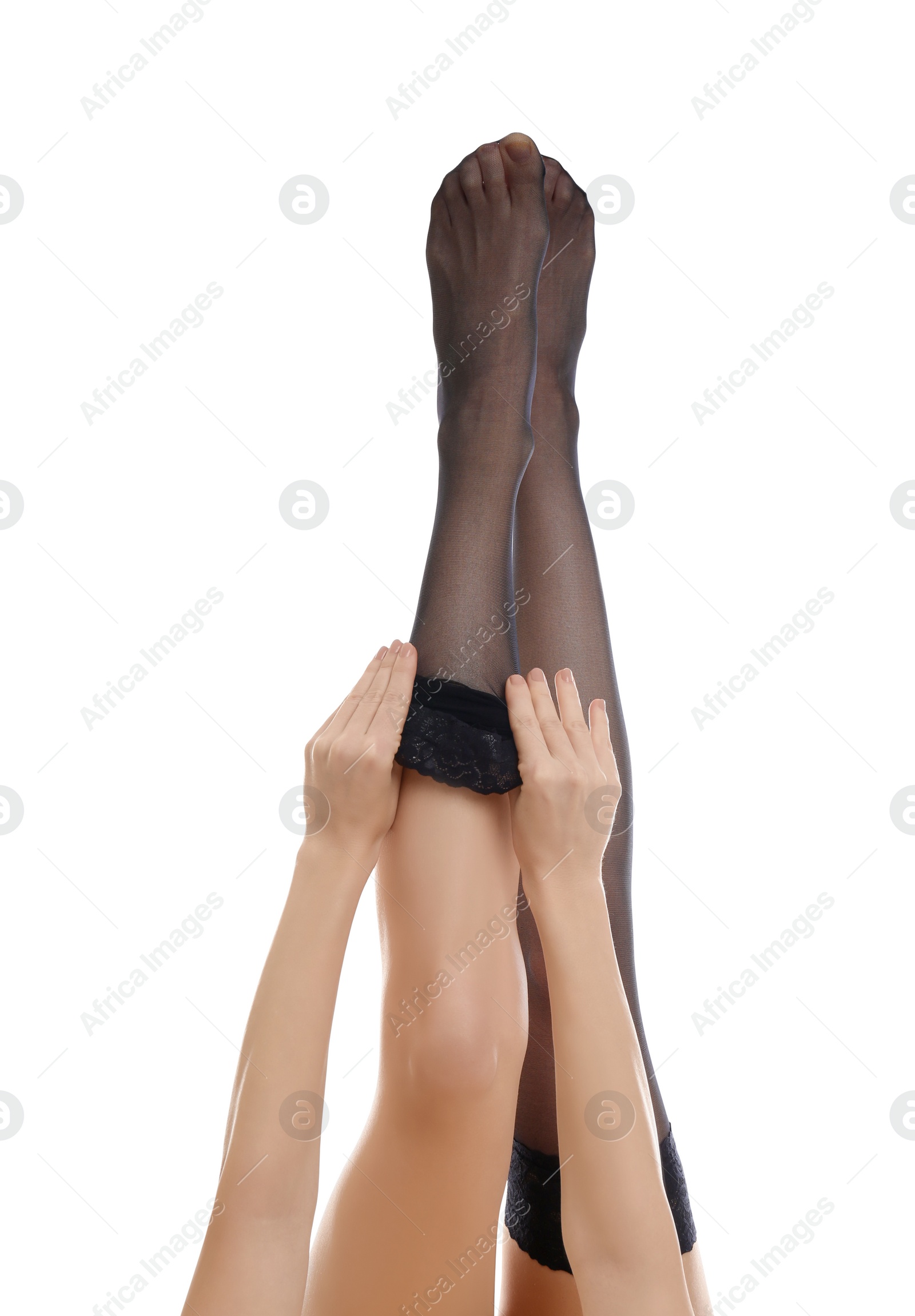 Photo of Young woman putting on stocking against white background, closeup