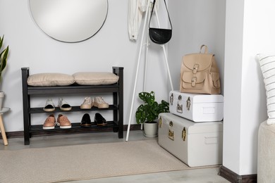 Photo of Hallway interior with shoe storage bench and houseplant