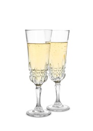 Photo of Glasses of sparkling champagne isolated on white