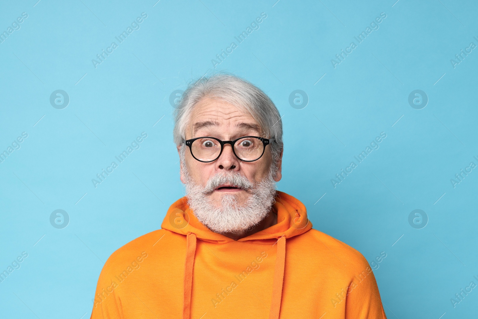 Photo of Senior man with mustache on light blue background