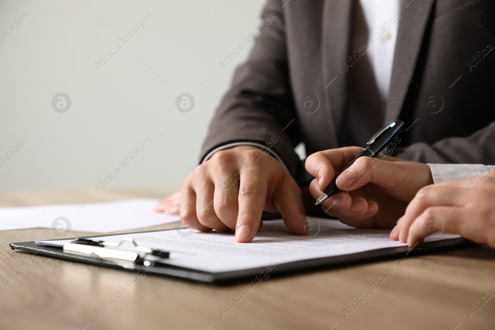 Photo of Businesspeople working with document at table indoors, closeup. Space for text