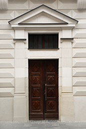 View of building with vintage wooden door. Exterior design