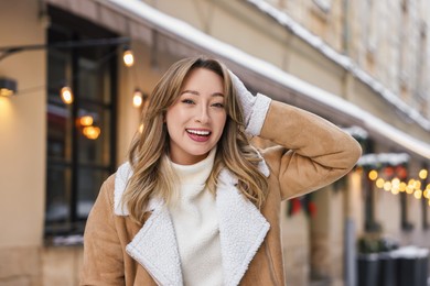 Portrait of smiling woman on city street in winter