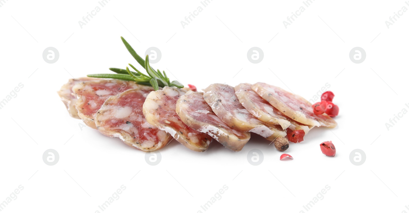 Photo of Slices of delicious fuet sausage with rosemary and pepper on white background