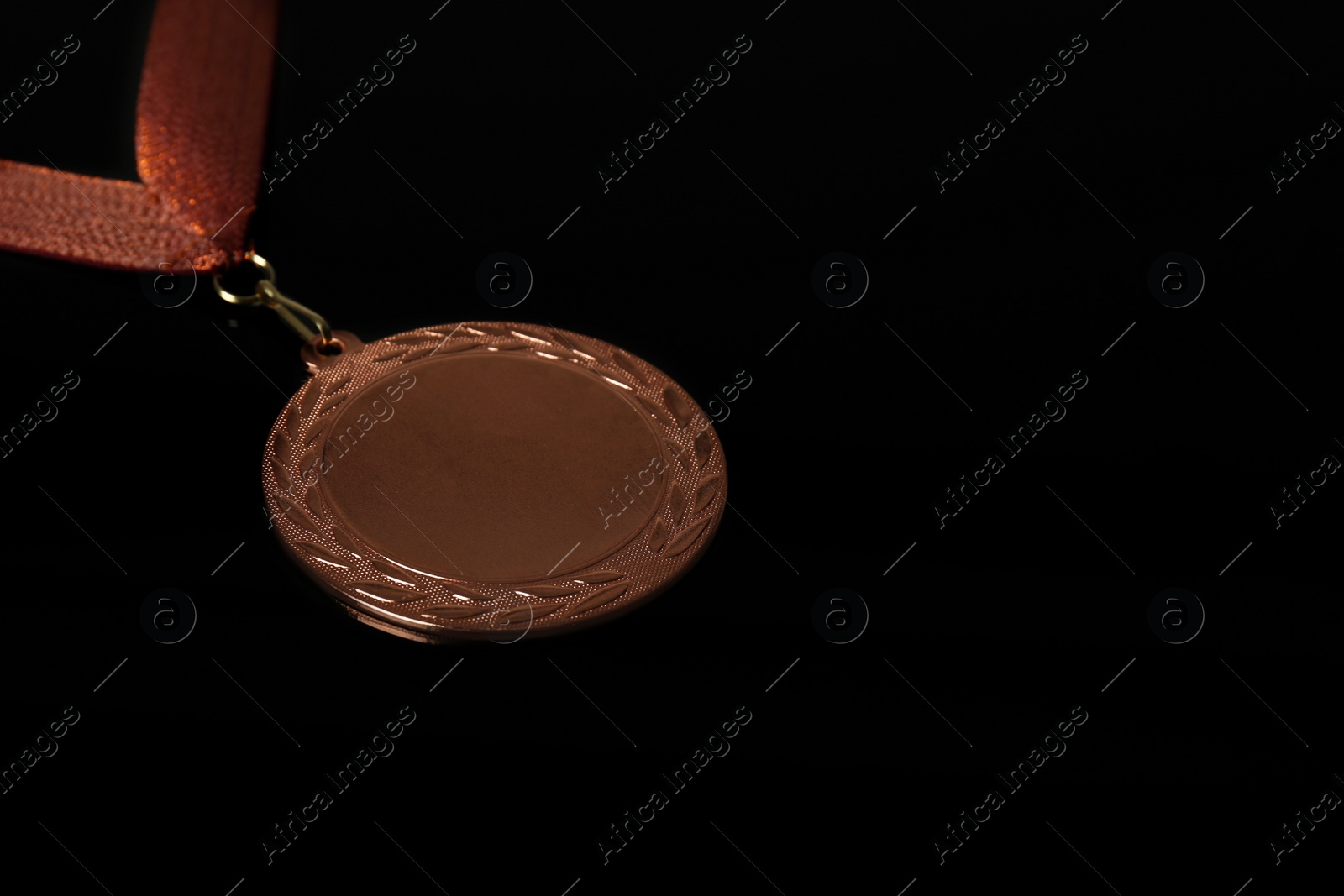 Photo of Bronze medal on black background. Space for design