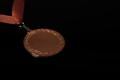 Photo of Bronze medal on black background. Space for design