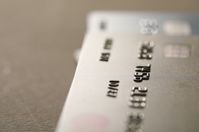 Photo of Credit card on beige background, closeup. Space for text