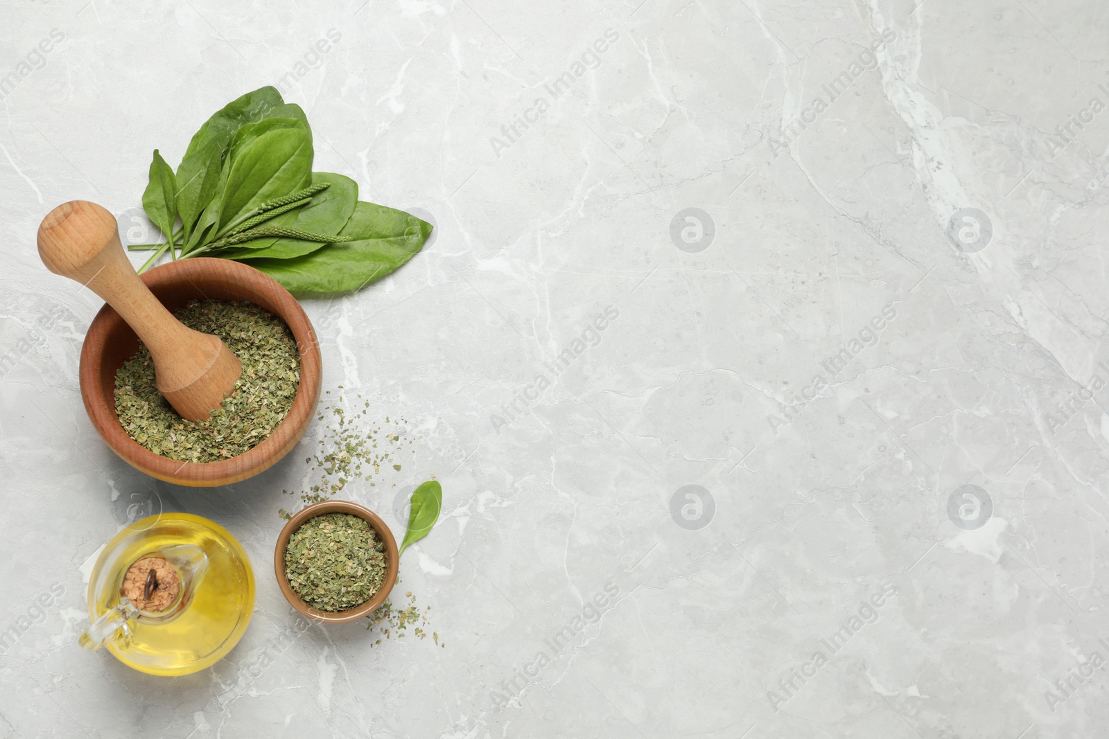 Photo of Flat lay composition with dried broadleaf plantain on grey marble table, space for text