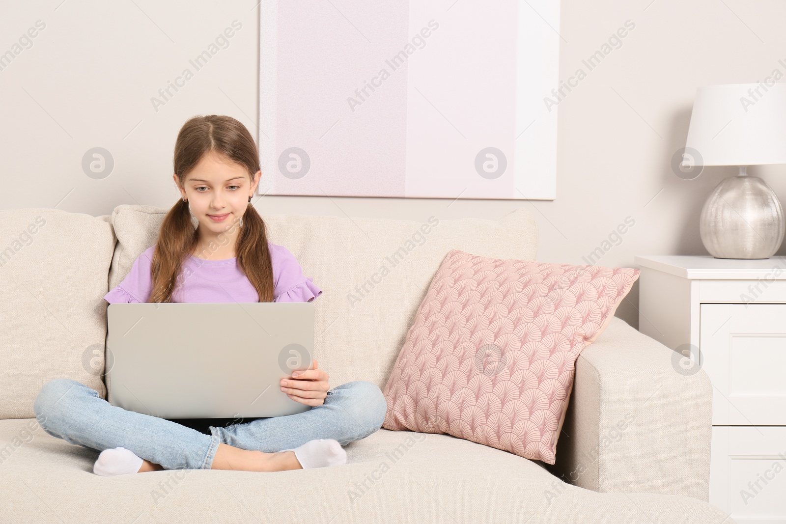 Photo of Girl with laptop on sofa at home