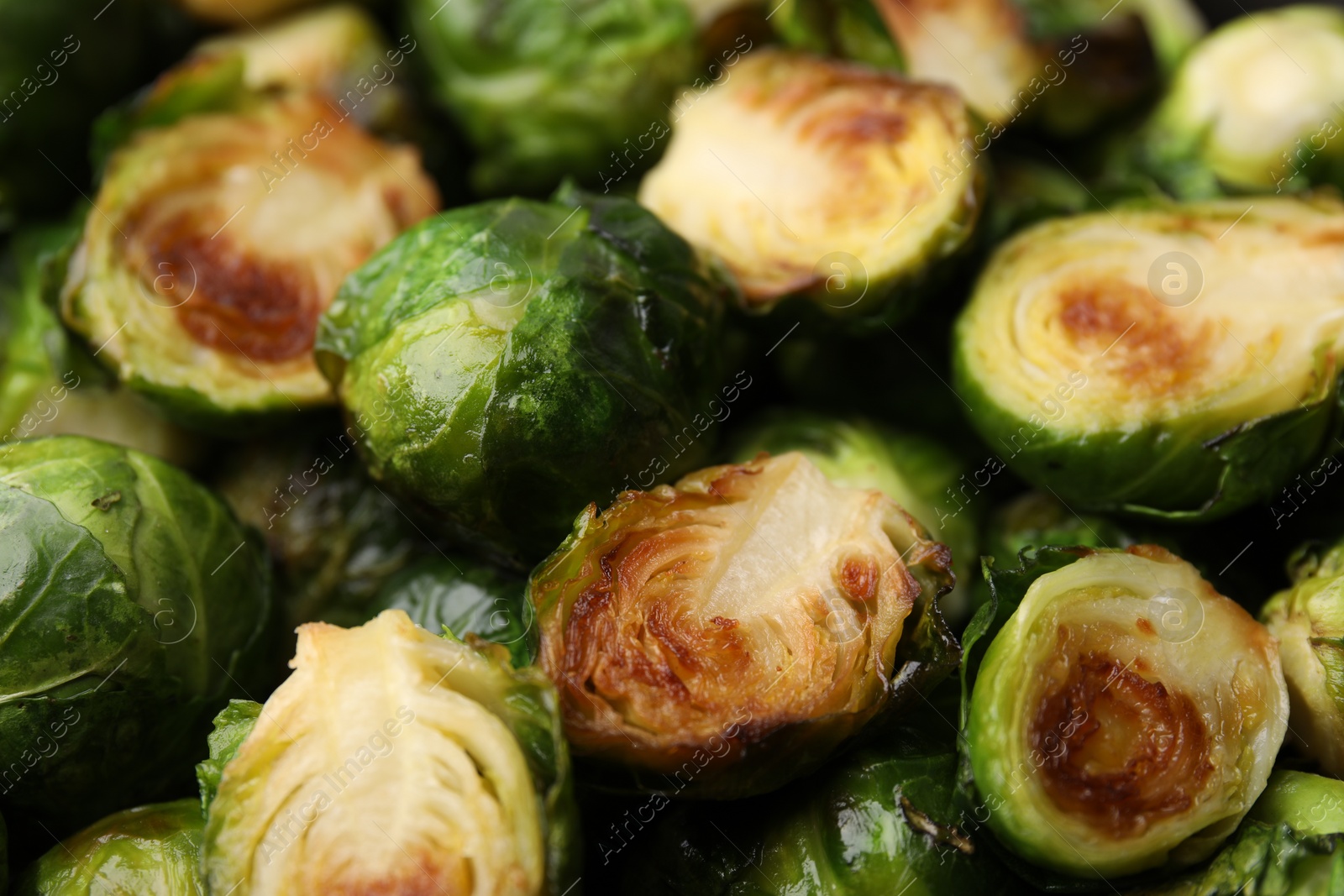Photo of Delicious roasted Brussels sprouts as background, closeup