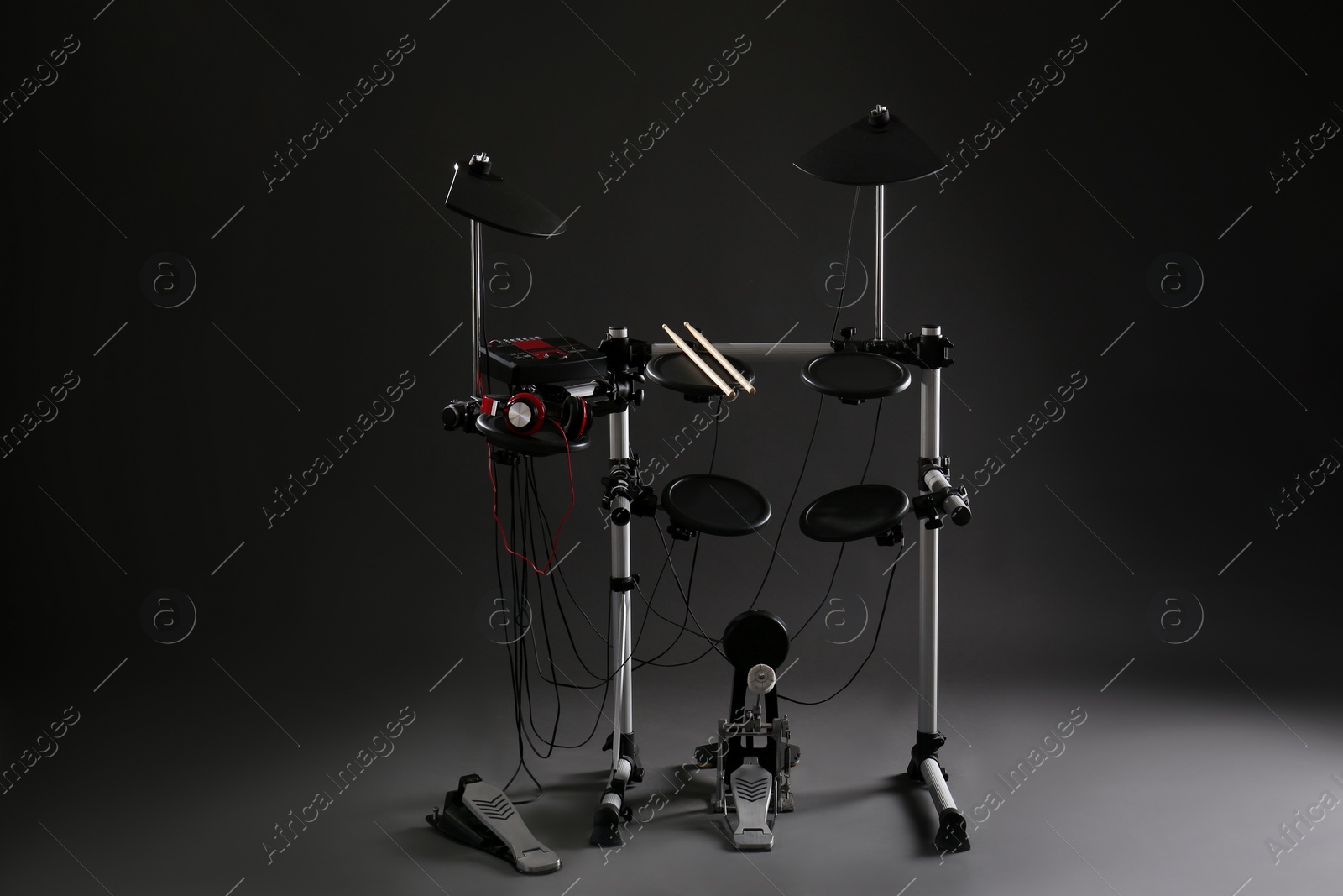 Photo of Modern electronic drum kit on dark background. Musical instrument